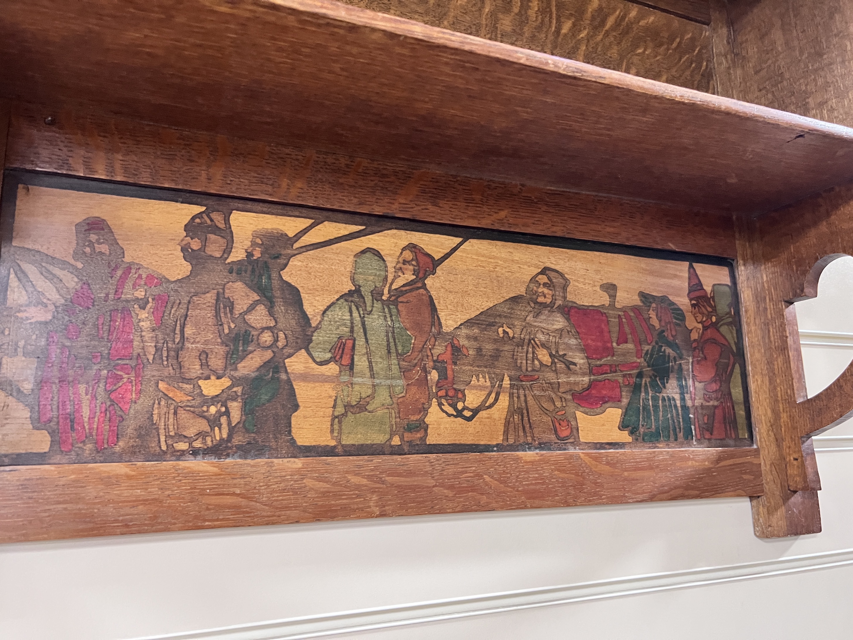 An Arts & Crafts oak shelf unit with stencilled decoration after Brangwyn, width 78cm, height 52cm